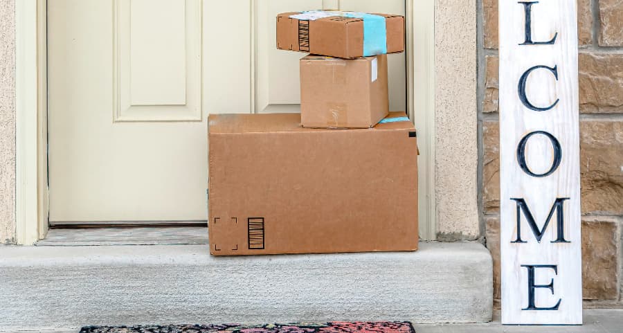 Deliveries on the front porch of a house with a welcome sign in Waco